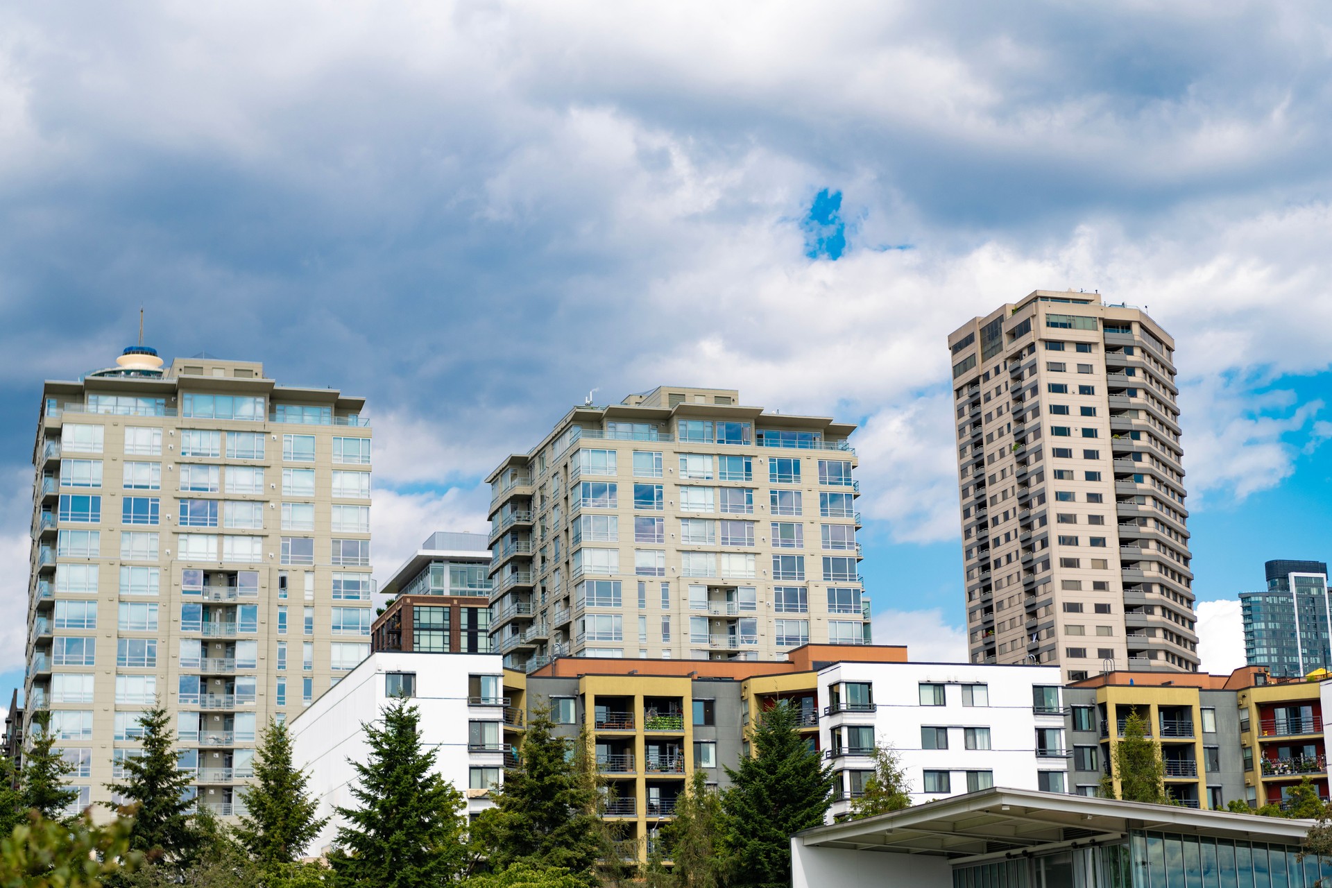 Modern condominium building. Architectural building in neighborhood. Building cityscape. Condominium architecture. Architecture of residential building. Residential house